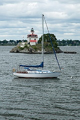 Sailboat Anchored by Lighthouse in Rhode island.